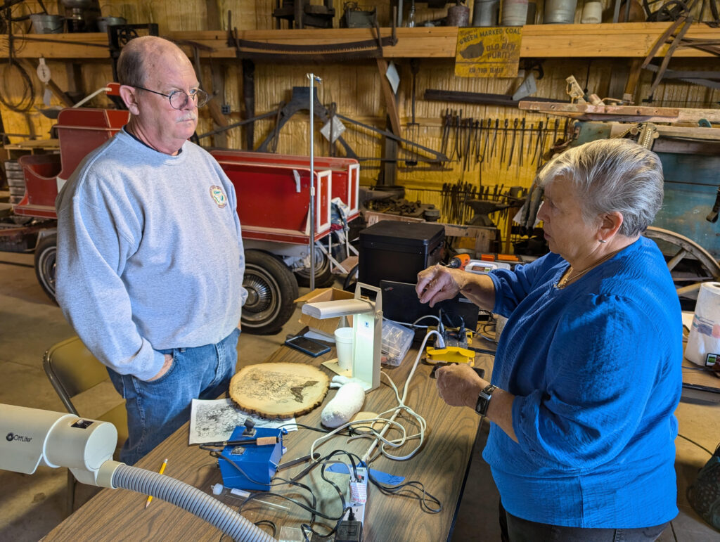 Pyrography instructor Marie McDonough shares her knowledge with a student